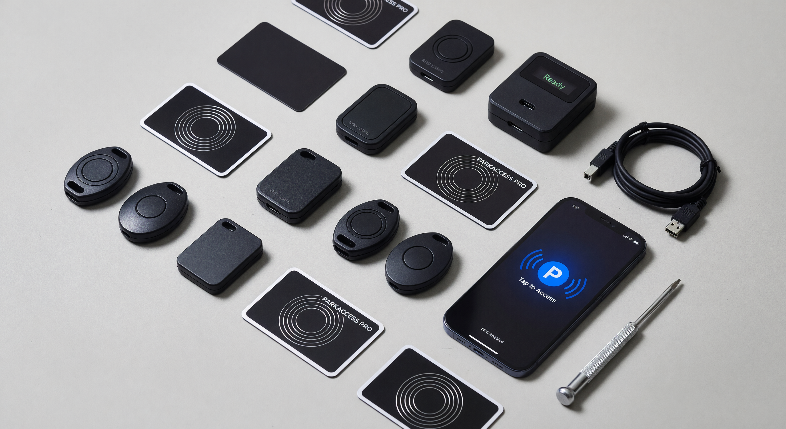 Collection of parking access credentials including cards, fobs, and a mobile credential app